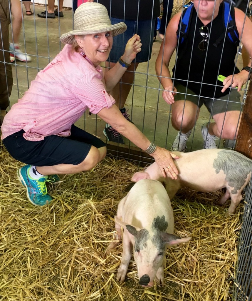 Jan (left) petting piglets.