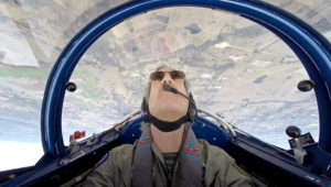 Upside down in the front seat of the Pitts.